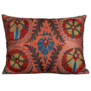 Rectangular silk suzani cushion with symmetrical floral design on pink ground with border