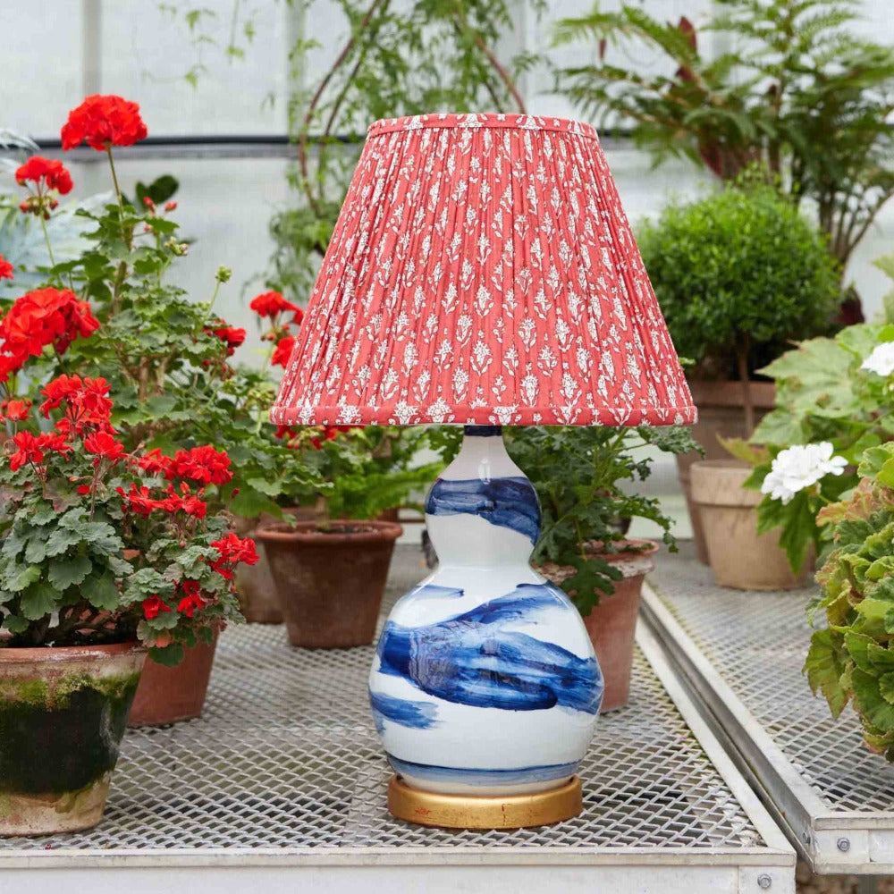 Hand-glazed ceramic lamp in a blue brush stroke glaze on a gold base by Bunny Williams Home