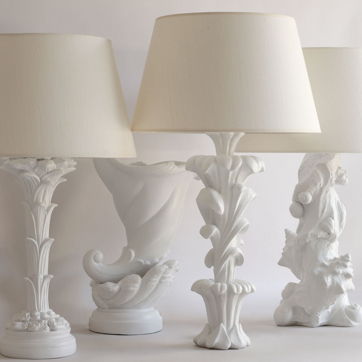 Decorative white lamps with intricate designs on a light background