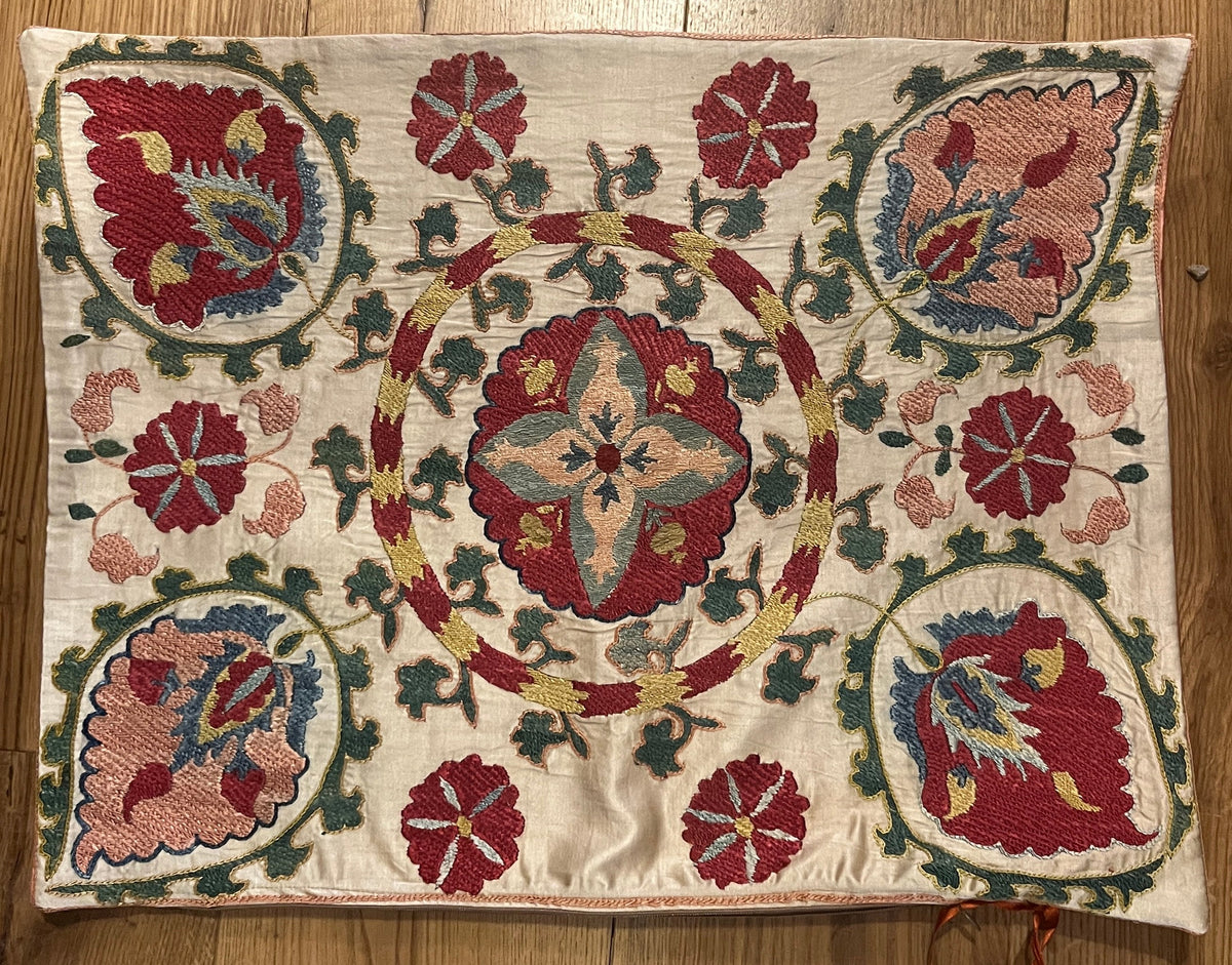 Rectangular silk suzani cushion with multicoloured Ottoman design on cream  ground